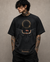 Person wearing a black t-shirt with a graphic design on a beige background