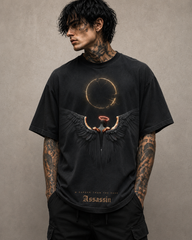 Person wearing a black t-shirt with a graphic design on a beige background
